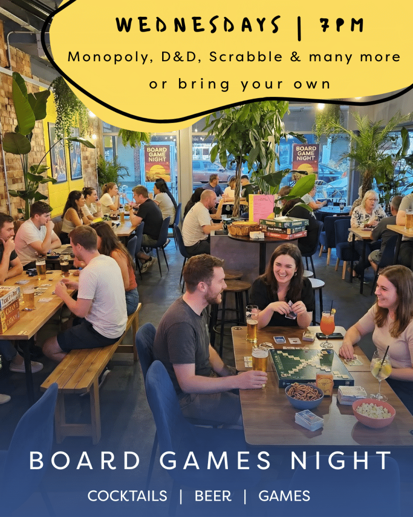 A bustling bar setting with people playing boardgames and having fun - additional information about the event above and below the image