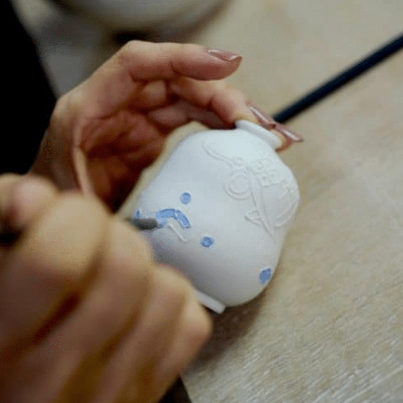 Hand painting a pot