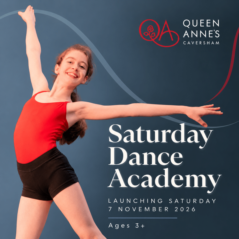 Girls in red leotard and black shorts performing a dance move with arms outstretched