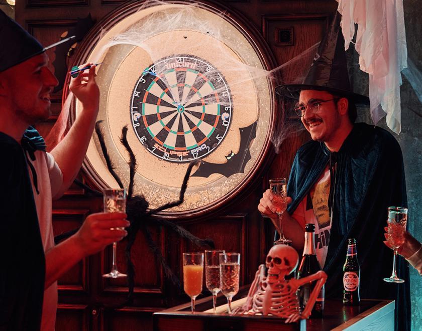 People playing darts in Halloween fancy dress